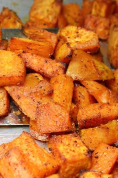 there are many pieces of cooked food on the counter top, including sweet potato wedges