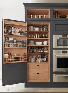 an open cabinet in the middle of a kitchen