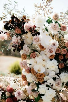 an arrangement of white and pink flowers on display at a wedding ceremony in the sun