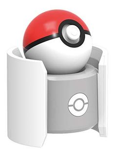 a poke ball sitting in the corner of a book holder with its door open to reveal it's contents