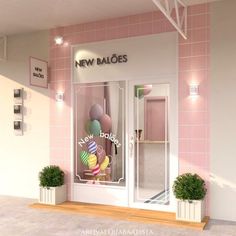 a pink and white store front with balloons in the window, next to potted plants