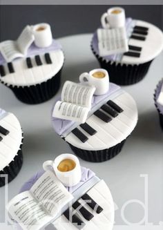 cupcakes made to look like piano keys with coffee and books on them, sitting on a plate