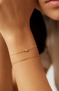 Dainty and delicate, this beautiful bracelet set was made to layer on your wrist. Waterproof and tarnish-free, this crafted in gold duo features a paperclip chain and classic linked chain with a lab-grown diamond. Made to last a lifetime Crafted in waterproof solid gold Set featuring two bracelets Length: 152mm - 6" + 31.7mm - 1.25"/ 152mm - 6" + 31.75mm - 1.25" Weight: 0.60g, 0.55g Chain Width: 1.3mm - 0.05", 0.8mm - 0.03" Carat: 0.06tcw Clarity: GHSI Stone Diameter: 2.5mm - 0.1" Spring Ring Cl Bridal Jewelry Bracelet, Cute Permanent Bracelets, Gold Jewelry Bridesmaids, One Diamond Bracelet, Wedding Jewelry Bracelet, Caitlin Minimalist Jewelry, Simplistic Gold Jewelry, Gold Bracelet Minimalist, All Gold Jewellery