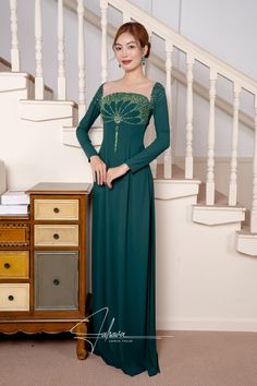 This floor length dress features a beautiful moss green fabric color, adorned with intricate beaded patterns. Its elegant design exudes sophistication and style, making it the perfect choice for any formal occasion. Elevate your wardrobe with this timeless piece.