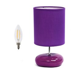 a purple table lamp next to a light bulb