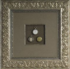 an ornate frame with two clocks on it