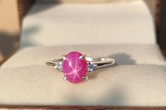 Pink star sapphire ring, Pink lindy star, 925 sterling silver, Silver ring, Birthstone ring, Engagement ring, Gift for her ★ Settings ☆ Metal - 925 Sterling Silver ☆ band Color - White ⍟ The ring size shown in the pictures is 7 US. ★ Main Stone ☆ Stone - Lab Created Pink Star sapphire ☆ Size - 6×8 mm ☆ Shape - Oval ☆ Color Grade- AAA ☆ Side Stone - Round CZ Diamonds ★ Links : ☆ Check out my shop - https://www.etsy.com/shop/BiswasJewels?ref=seller-platform-mcnav ★ Notes : ☆ Don't forget to hit the favorite button in order to track the item on your favorites/wish list. ☆ Please leave your phone number at checkout for delivery purposes. Buyer Note :- The Buyer is Fully Responsible For Any Charges , Import, Custom Duties and Taxes in Buyer Country . Returns Policy We offer 100% Money Back Guar Elegant Star-shaped Sapphire Promise Ring, Elegant Star-shaped Sapphire Ring, Star Sapphire Ring, Saphir Ring, Pink Star, Ring Birthstone, Star Sapphire, Pink Stars, The Favorite