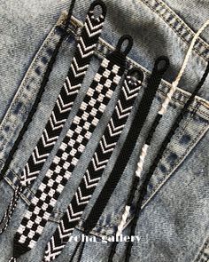 some scissors are sticking out of the back pocket of a pair of denim jeans with black and white stitching