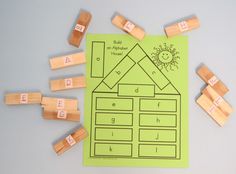 a green paper with some wooden blocks on top of it and letters that spell out the word build