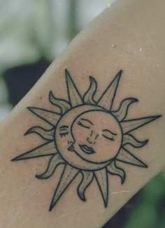 a sun tattoo on the arm with a woman's face