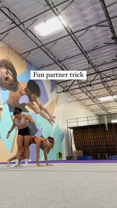 three women are doing exercises in front of a mural