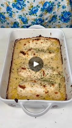 a casserole dish with cheese and herbs in it