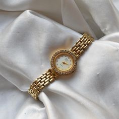 Women's EJ gold toned clasp band style watch. gold circular face with silver numbers and gold hands. Approximately 7.75 inches - rhinestone details around and on the face . TICKING/WORKING - new battery Cleaned, polished, refurbished, and tested to the best of my ability. coastal grandmother, coastal granddaughter, clean girl, vanilla girl, old money, coquette, soft girl, lo fi, maximalist, y2k, sad girl, twee, academia, plazacore, whimsigoth, weird girl, fairycore, kidcore, gorpcore, minimalist, retro, indie, skater, baddie, techwear, cottage core, dark academia, barbiecore, angelcore, balletcore, coastal cowgirl, countrycore, preppy, craftcore, normcore, vacationcore, europecore, italycore, quiet luxury, vintage, avant garde Cottage Core Dark Academia, Cottage Core Dark, Money Coquette, Old Money Coquette, Weird Girl, Minimalist Retro, Silver Numbers, Coastal Granddaughter, Coastal Grandmother