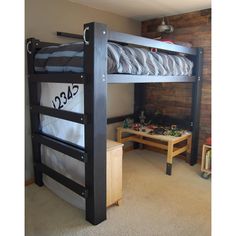 a bunk bed in a room with a table and toys on the floor next to it