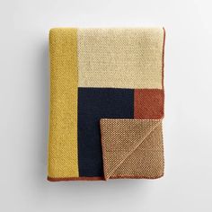 a blanket that has different colors and shapes on the top, one with a square design