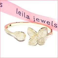 A designer-inspired confection of sparkle! This amazing bracelet is a piece of art that you wear to dazzle. A slim, 3mm band circles your wrist and is topped at each end with gracefully curved flower petals, 5 in total - each petal heavily crusted with zirconia pavé. The pavé stones extend down the band for an inch on each side of the flower as well. The bangle is hinged so you can easily slip it on and off your wrist. Available in silver stainless steel or gold plated stainless steel. Imported Gift Diamond Bangle Bracelet With Rhinestones, Gift Rhinestone Bangle Diamond Bracelet, Dazzling Pave Setting Bracelet Gift, Glamorous Diamond Bracelet As Gift, Glamorous Diamond Accented Bracelets As Gift, Glamorous Bracelets With Diamond Accents As Gift, Glamorous Diamond Accents Bracelet For Gift, Sparkling Flower Diamond Jewelry, Rhinestone Bangle Cuff Bracelet As Gift