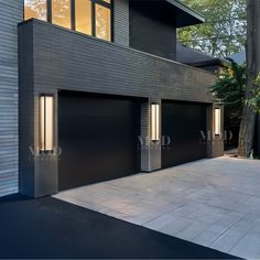 two garage doors are open in front of a house