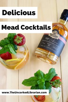 two glasses filled with different types of alcohol and strawberries next to each other on a wooden table