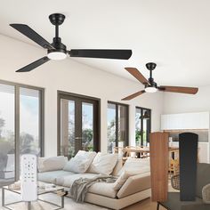 a living room filled with furniture and a ceiling fan mounted to the side of a wall