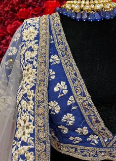 Subtle hues of whimsy blend with floral embroideries in this Royal Blue lehenga. The mehreen lehenga, embroidered with beautiful floral motifs and golden embroidery work, looks every bit of the royal self! Color - Fabric & Work Style -- Silk lehenga: Rich embroidery, floral embroidery work.- Silk embroidered blouse.- Net dupatta. Details -- Assured quality.- Wash care instruction: Dry clean only.- Slight variation in color is possible due to digital photography. Floral Embroidered Sharara With Traditional Drape For Wedding, Floral Embroidery Sharara With Traditional Drape For Wedding, Wedding Sharara With Floral Embroidery And Traditional Drape, Floral Embroidered Choli For Eid Reception, Floral Embroidered Choli For Reception Eid, Floor-length Dupatta With Intricate Embroidery For Festive Occasions, Wedding Sharara With Floral Embroidery In Dola Silk, Floral Embroidery Sharara For Diwali Wedding, Wedding Sharara With Floral Embroidery For Diwali