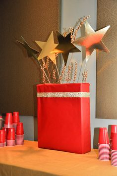 there is a red bag with stars on it and some cups in front of it