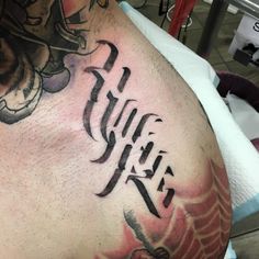 a close up of a person with a tattoo on his arm and shoulder that has the word faith written in cursive writing