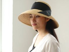 "I just adore classic movie stars wearing their hats so elegantly. This Casablanca style hat, \" Holly\", is inspired by those classic movies, and also added modernity for today. The wide brim is nicely curved to the end, covers perfectly your face from sunshine. Material is natural, narrow good quality straw, which you hardly find in mass products nowadays. Please chose ribbon colour black, white, beige and grey. I attached the ribbon to the side by sewing. If you wish to show in the front or b Elegant Straw Visor Hat, Elegant Boater Hat With Visor For Spring, Elegant Spring Boater Hat With Visor, Elegant Visor Boater Hat For Vacation, Elegant Summer Panama Visor Hat, Elegant Boater Hat With Visor For Vacation, Elegant Visor Sun Hat For Kentucky Derby, Elegant Visor Sun Hat For The Kentucky Derby, Elegant Summer Visor Hat