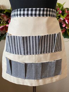 a woman's apron with black and white checks on it