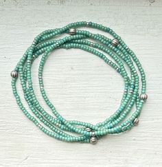 Made with sage green Czech glass seed beads and complementary corrugated antiqued silver metallic beads, our wrap bracelets are designed to add a touch of bohemian flair to any outfit. Handcrafted with strong elastic cording, these stretchy bracelets effortlessly wrap around your wrist five times or around your neck two times as a choker-style necklace, providing a comfortable, lightweight, durable fit for all-day wear and active outdoor play.Each bracelet features a beautiful combination of seed beads and metallic silver or gold beads for a bit of flair. Whether you're stacking them up with other wraps or wearing them solo, these versatile beaded wrap bracelets for women are perfect for adding a pop of color and free-spirited boho-chic style to any ensemble. Due to the nature of the handm 365 Questions, Silver Sprinkles, Choker Style Necklace, Beaded Wrap Bracelets, Wrap Bracelets, Beaded Wraps, Boho Bracelet, Choker Style, Stretchy Bracelets