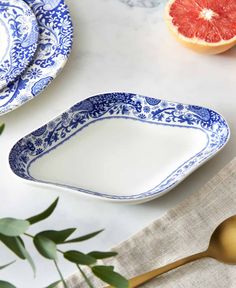 blue and white dishes with grapefruits in the background