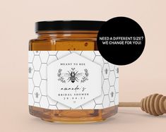 a jar of honey next to a wooden stick with the label meant to be change for you