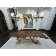 a large wooden table sitting in the middle of a room with chandeliers hanging from it