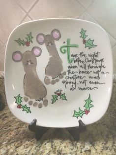 a white plate with two handprinted mouses on it, and the words we're right before christmas