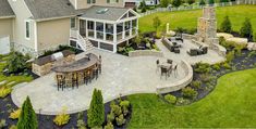 an aerial view of a patio and outdoor dining area in a large home's backyard