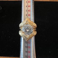 a diamond ring sitting on top of a ruler