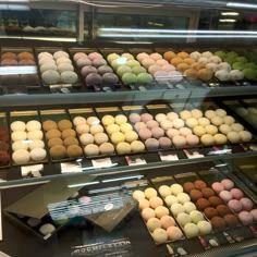 a display case filled with lots of different types of donuts