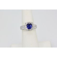 a blue and white diamond ring sitting on top of a napkin