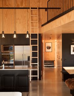 the interior of a modern house with wood paneling