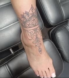 a woman's foot with a tattoo on it