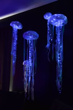 three jellyfish lights hanging in the dark