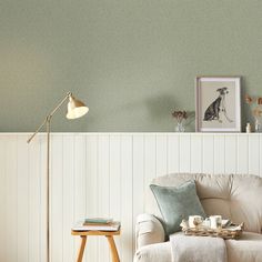 a living room filled with furniture and a lamp on top of a wooden table next to a white couch