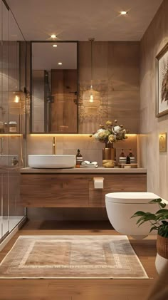 a bathroom with a toilet, sink and bathtub next to a plant on the floor