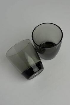 two black and white glass cups sitting next to each other