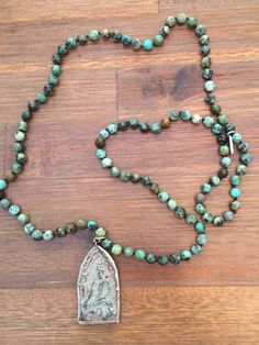 This African Turquoise Beaded Buddha Mala Necklace is exquisite quality!Handmade beaded African Turquoise prayer beads meditation necklace. This lovely pendant is made in Thailand from a mold patterned after an antique mold that has been used for making sacred amulets for over 500 years.  Beads are 6mm and the pendant is 2 inches long 1 inch wide. Adjustable Spiritual Turquoise Necklace For Meditation, Turquoise Polished Beads Spiritual Necklaces, Turquoise Spiritual Beaded Necklaces With Polished Beads, Spiritual Turquoise Necklace With Round Beads For Healing, Turquoise Spiritual Beads For Meditation, Spiritual Turquoise Beads For Meditation, Turquoise Spiritual Polished Beads, Spiritual Turquoise Beads With Natural Stones, Turquoise Spiritual Beads With Natural Stones