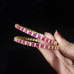 "* Handcrafted Gold Plated 2 Bangle Set. * Bangles with pretty Semi-Precious Ruby and CZ stones * High Quality 22 K Gold Plated- 2 Bangle set Bangle sizes: 2.6 ( 2.43\" diameter of the inner circle); 2.8 (2.54\" diameter of the inner circle) 2.10 ( 2.68 \" diameter of the inner circle) * Sold as a set of 2. Gorgeous gold-plated bangle/ bracelet best exemplifies the careful craftsmanship done on it -- a specialty at Nemali Jewelry. It has a special tone of elegance attached to it. The intricate h Wedding Bangle With Gemstone, Ruby Bracelet With Stone Work For Gift, Ruby Bracelets With Stone Work For Wedding, Ruby Bracelets With Stone Work As Gift, Ruby Bracelet With Stone Work As Gift, Yellow Gold Bracelet With Stone Work For Gift, Ruby Bangle With Stone Work For Wedding, Jeweled Bangle For Diwali Gift, Stone Work Bangle As A Gift