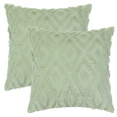 two light green pillows with fringes on them