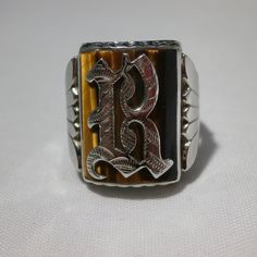 "Another cool ring for the guys! Bold ring that will make a statement. This is a 10k white gold men's ring. It will fit approx. a size 8.5 so a woman could wear as well. Sizable and good weight at 6.6 grams. Nice fan detailing on the sides and a scalloped edge on top and bottom of frame. Bezel set is a large Tigers Eye gemstone. Stone is approx. 3/4 inches long and 5/8 inch wide. Center is set with a script Gothic letter. Not sure what the letter is, font is a bit unusual, but I would guess a le Silver Formal Jewelry With Initials, Vintage Wedding Jewelry With Initials, Antique Personalized Jewelry For Formal Occasions, Antique Personalized Formal Jewelry, Sloth Accessories, Smiling Sloth, Sloth Necklace, Gold Mens Ring, Gothic Script