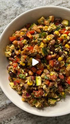 a white bowl filled with food on top of a table