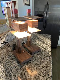 a kitchen counter top with an island made out of wooden boxes on it and a refrigerator in the background