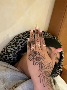 a woman's hand with tattoos on it